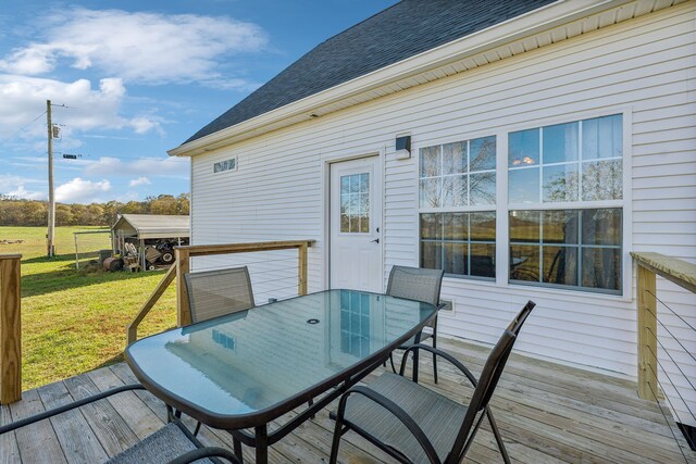 wooden deck featuring a yard