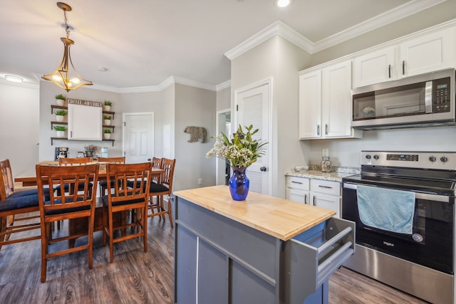 kitchen featuring hanging light fixtures, appliances with stainless steel finishes, dark wood-type flooring, and white cabinetry