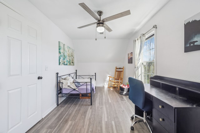 home office with vaulted ceiling, wood finished floors, and a ceiling fan