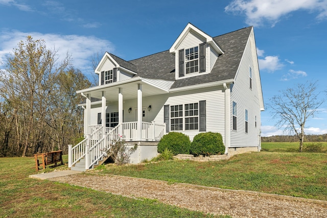 cape cod home featuring a front yard and covered porch