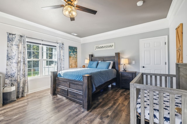 bedroom with ceiling fan, dark wood-style flooring, visible vents, baseboards, and ornamental molding