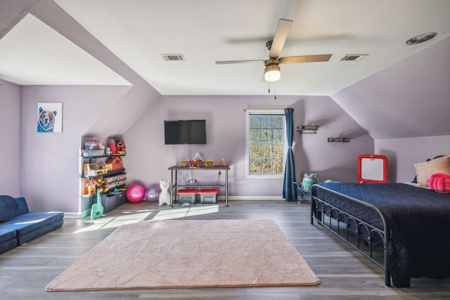 bedroom with lofted ceiling, baseboards, visible vents, and wood finished floors