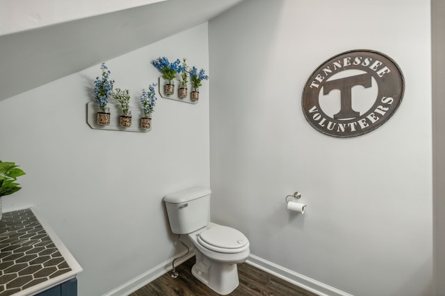 bathroom featuring toilet, baseboards, and wood finished floors