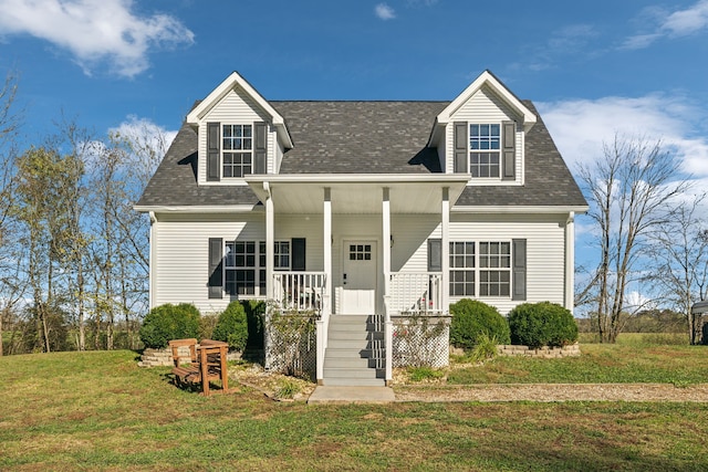 cape cod house with a porch, a front yard, and roof with shingles