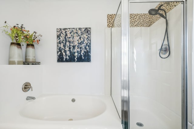 bathroom with a garden tub and a shower stall