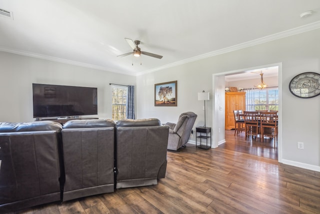 living area with crown molding, dark wood-style flooring, and plenty of natural light