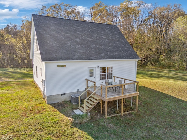 rear view of house with a wooden deck, cooling unit, and a yard