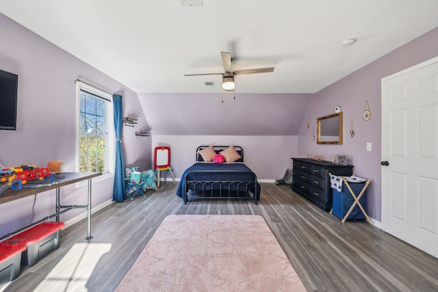 bedroom featuring dark hardwood / wood-style floors, ceiling fan, and vaulted ceiling