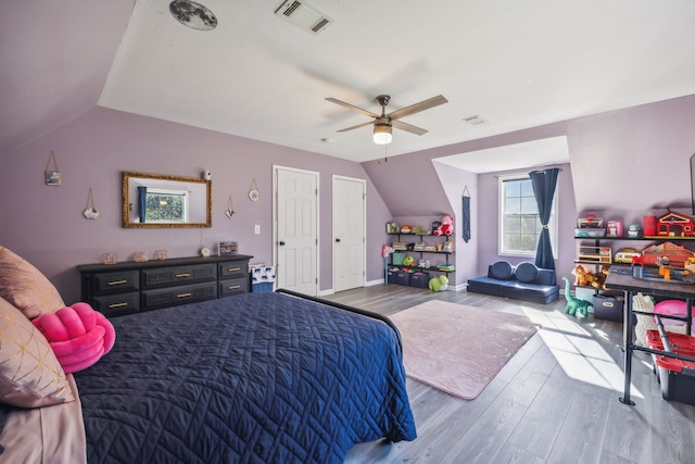 bedroom with hardwood / wood-style flooring, lofted ceiling, and ceiling fan