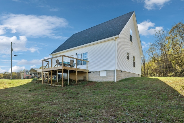 back of property featuring crawl space, a deck, and a lawn