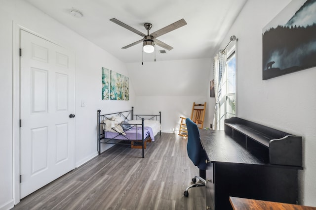 home office featuring ceiling fan, wood-type flooring, and vaulted ceiling