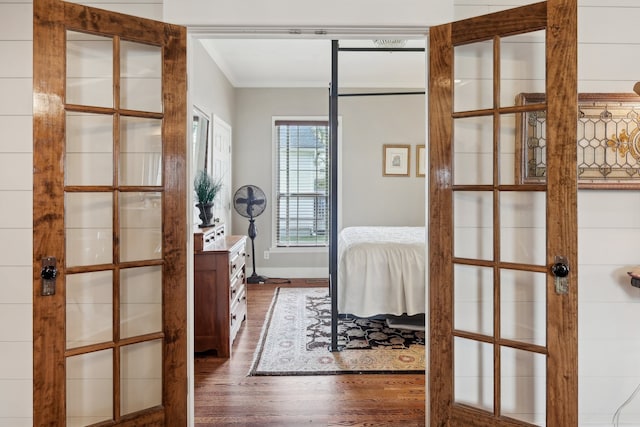 bedroom featuring french doors and dark hardwood / wood-style flooring