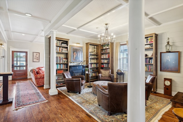 sitting room with dark hardwood / wood-style flooring, a chandelier, decorative columns, beamed ceiling, and coffered ceiling