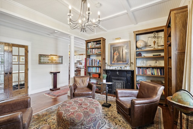 living area featuring decorative columns, coffered ceiling, wooden walls, crown molding, and dark hardwood / wood-style floors