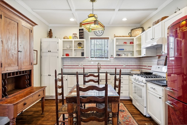 kitchen featuring decorative backsplash, gas range gas stove, hanging light fixtures, and dark hardwood / wood-style flooring