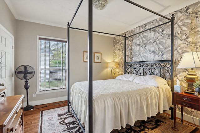 bedroom with dark wood-type flooring and ornamental molding