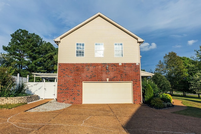 101 Brookstone Dr, Burns, TN 37029 - view of side of home featuring concrete driveway, brick siding, fence, and a garage