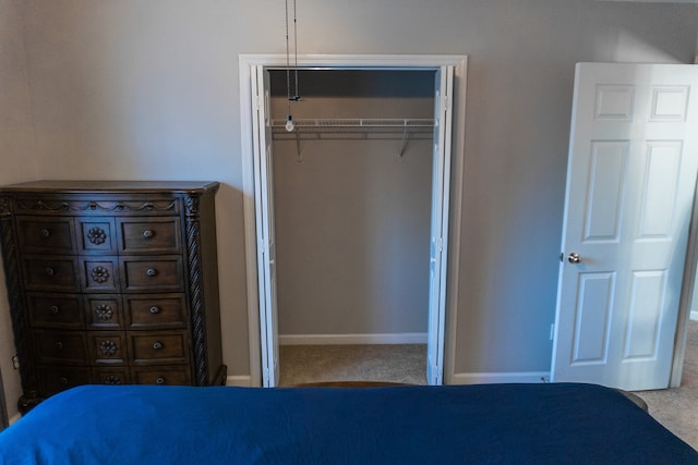 unfurnished bedroom featuring a closet and light colored carpet