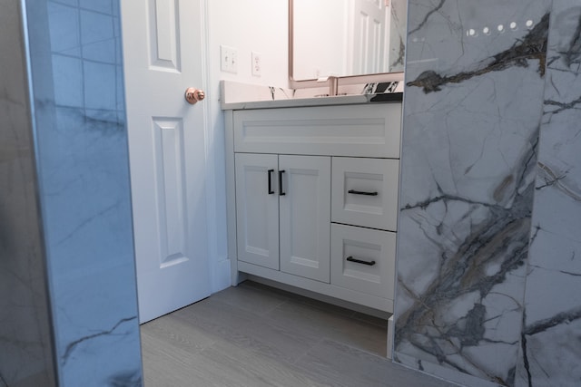 bathroom with vanity and wood-type flooring