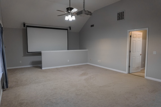 home theater room with light colored carpet, high vaulted ceiling, and ceiling fan