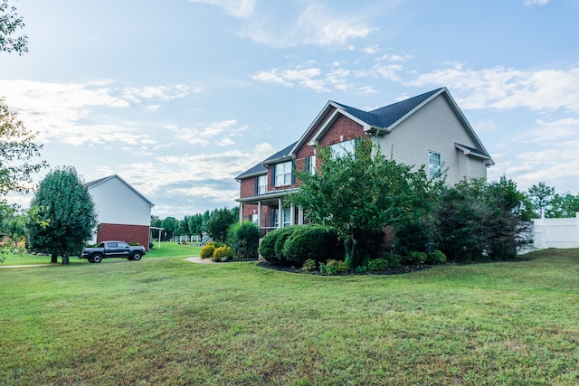 view of side of home with a yard