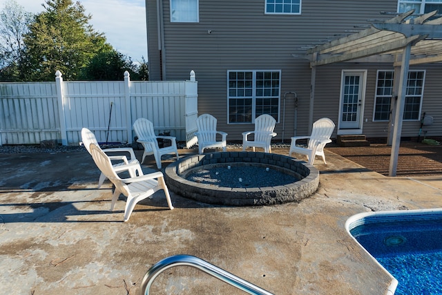 view of patio featuring an outdoor fire pit, a pool, and a pergola