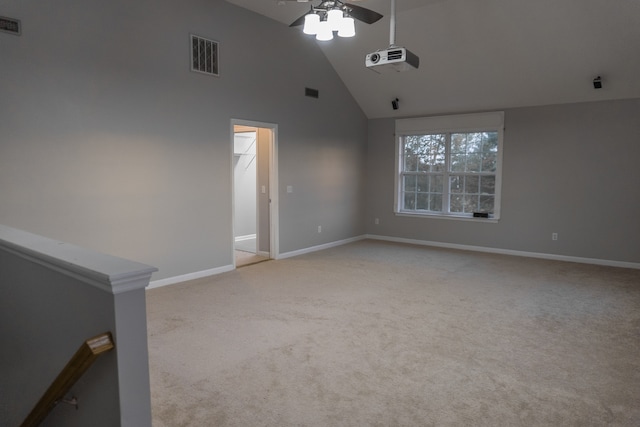 unfurnished room featuring ceiling fan, high vaulted ceiling, and light colored carpet