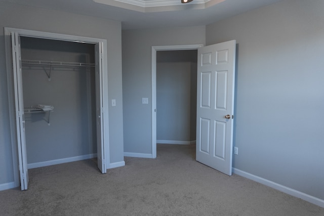 unfurnished bedroom with light carpet and a closet