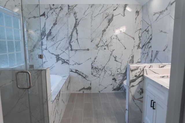 101 Brookstone Dr, Burns, TN 37029 - full bathroom with vanity, toilet, tile walls, a tub with marble appearance, and a marble finish shower