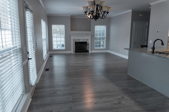 101 Brookstone Dr, Burns, TN 37029 - unfurnished living room with crown molding, baseboards, a sink, and a fireplace