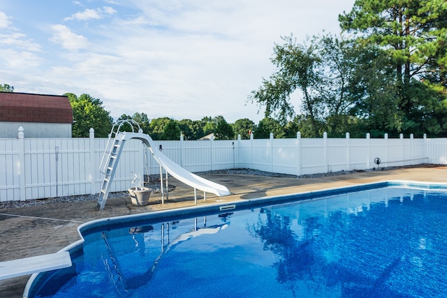 view of swimming pool featuring a water slide