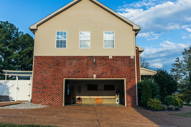 101 Brookstone Dr, Burns, TN 37029 - exterior space featuring concrete driveway, brick siding, a gate, and a garage
