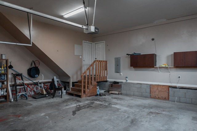 garage with a garage door opener and electric panel