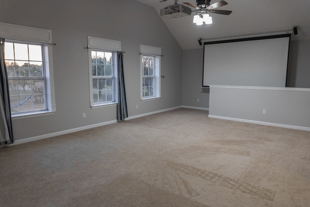 carpeted cinema room with lofted ceiling, plenty of natural light, and ceiling fan