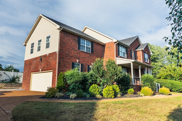 view of side of home featuring a garage and a lawn