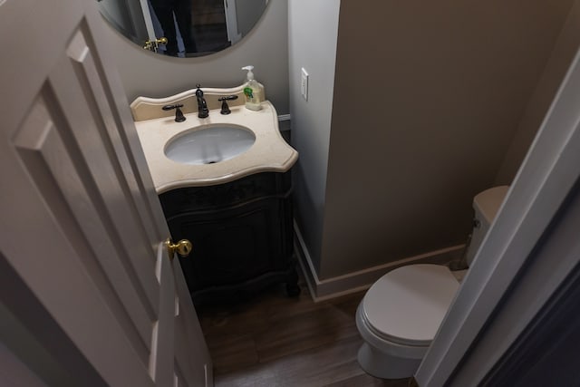 bathroom with vanity, hardwood / wood-style floors, and toilet