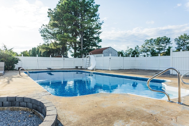 view of pool featuring a patio and a water slide