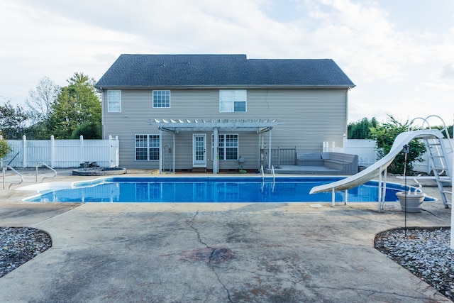 view of pool featuring a water slide and a patio