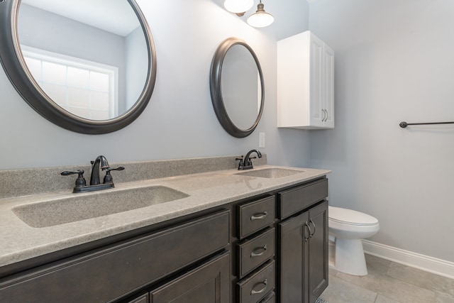 bathroom featuring vanity, toilet, and tile patterned flooring