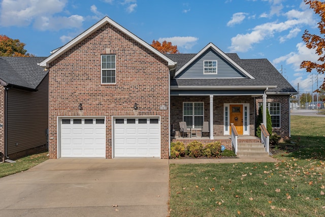 front facade featuring covered porch, a garage, and a front yard