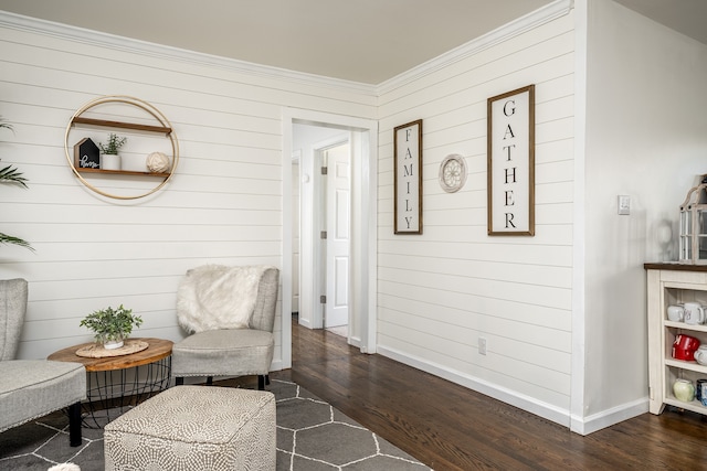 living area with ornamental molding and dark wood-type flooring