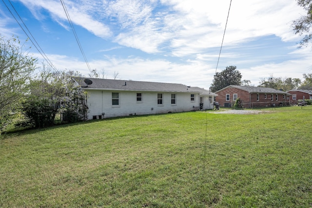 back of house featuring a yard