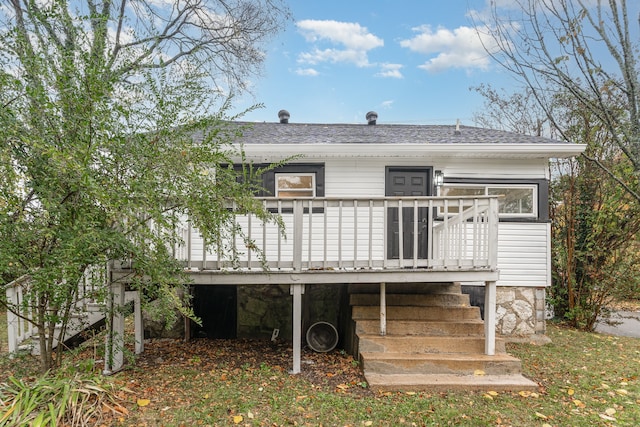 rear view of property featuring a deck