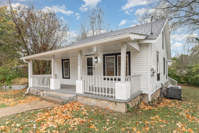 bungalow featuring a porch and cooling unit