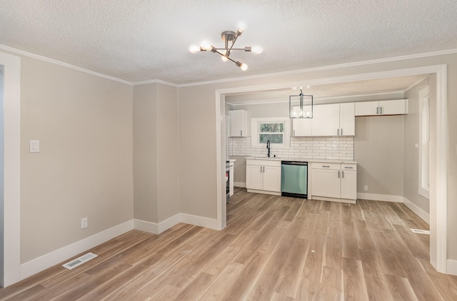 1828 S Main St, Columbia, TN 38401 - kitchen featuring dishwasher, a chandelier, a sink, a textured ceiling, and ornamental molding