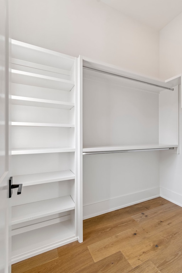 pantry with hardwood / wood-style flooring