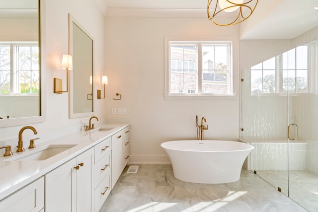 bathroom with plenty of natural light, separate shower and tub, and vanity