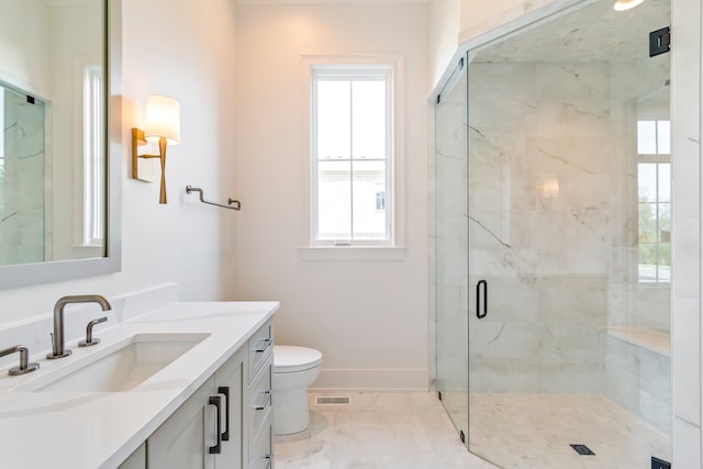 bathroom featuring vanity, toilet, and walk in shower