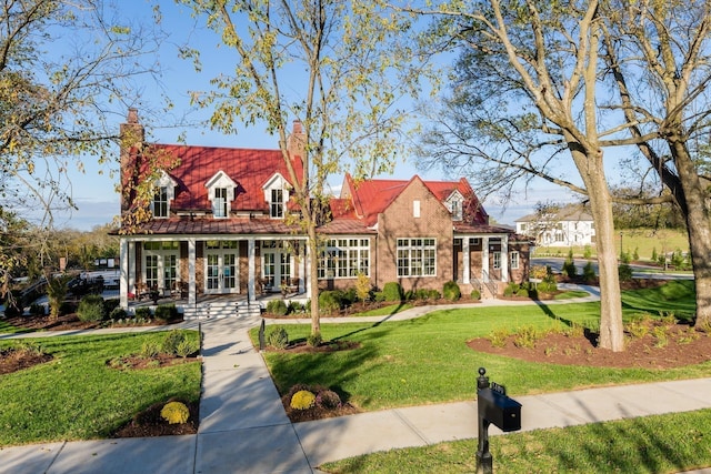 cape cod home with a front lawn