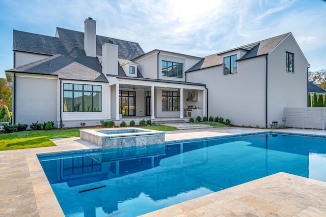 back of house featuring a pool with hot tub and a patio area